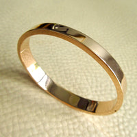 high polish 14k gold vintage hinged bangle on beige leather background