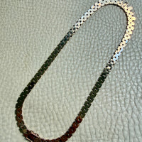 vintage 14k gold chain necklace on with hexagonal links on a textured surface
