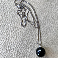 Brilliant! Black onyx faceted orb pendant necklace set in 18k white gold with 0.05 ct brilliant cut diamond by Ole Lynggaard