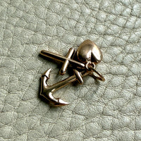 vintage 14k gold faith hope charity symbol charms on textured surface