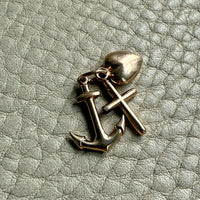 vintage 14k gold faith hope charity symbol charms on textured surface