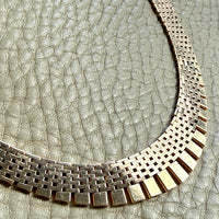 14k gold vintage cleopatra necklace on a textured gray surface penelopepenelope.com