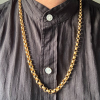 vintage rolo 18k Gold chain necklace on a person wearing a dark shirt with visible buttons.
