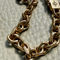 18k gold vintage biker link chain bracelet on gray textured surface penelopepenelope.com