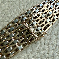 18k Gold bracelet on a textured light gray surface