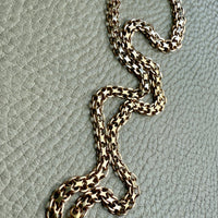 Gold chain on a textured gray surface
