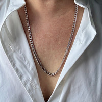 14k white gold chain necklace worn by a person in a white shirt