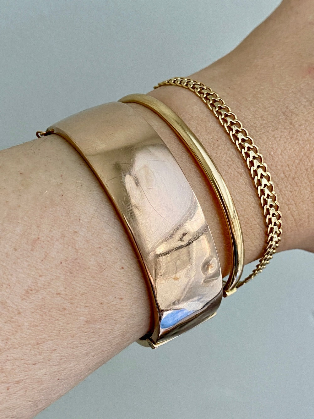 A solid gold hinged bangle made in 1978 in Sävsjö, Sweden. Solid bangles like this are rare finds! What I love about them is that they cannot dent - this style is a solid bar of gold!  This amazing vintage Scandinavian 18k gold bangle is oval shaped with a femme half-round cross section. Interior of the oval measures 2 inches (50mm) x 2.4 inches (60mm) and opens with a well working and beautiful hinge. She weighs an excellent 18.2g