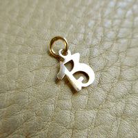Lucky 13 - 14k gold vintage charm or pendant - 0.64 inch on beige background