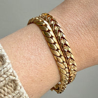2 vintage Gold link bracelets on a wrist with a neutral background penelopepenelope.com