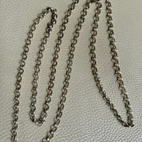Silver chain on a textured gray surface
