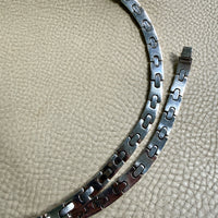 vintage silver necklace on a textured beige surface