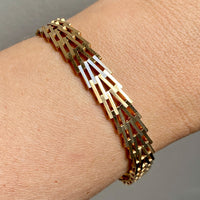 A person wearing a vintage Danish gold Geneva link bracelet on their wrist.