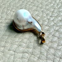 Pearl pendant on a textured gray surface