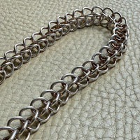 Danish vintage Silver chain necklace on a textured green surface