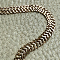 gold chain on a textured gray surface