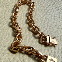 18k gold vintage biker link chain bracelet on gray textured surface penelopepenelope.com