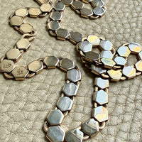 vintage 14k gold Necklace with hexagonal link on a textured beige surface penelopepenelope.com