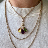 Necklace with colorful gemstones on a white sweater