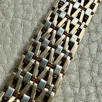 vintage 18k Gold link bracelet with a woven pattern on a textured surface