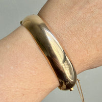 vintage 14k gold hinged bangle on wrist