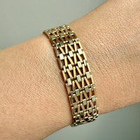 Gold bracelet on a wrist with a neutral background. Penelope Penelope Vintage Gold Jewelry