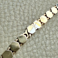 vintage 14k gold Necklace with hexagonal link on a textured beige surface