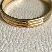 Made in 1952 - 18k gold hinged bangle with ridged hemispheres