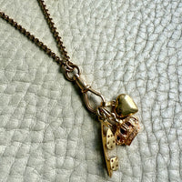 Necklace with heart-shaped pendant on a textured light gray background