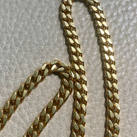 Gold chain on a textured gray surface