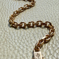 18k gold vintage biker link chain bracelet on gray textured surface penelopepenelope.com