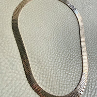 14k gold vintage cleopatra necklace on a textured light gray surface