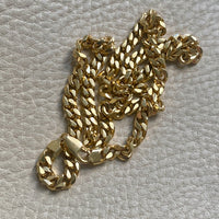 Gold chain on a textured gray surface