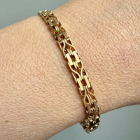 Gold bracelet on a wrist with a neutral background. Penelope Penelope Vintage Jewelry