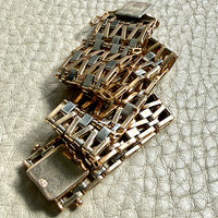 vintage 18k Gold link bracelet with a woven pattern on a textured surface