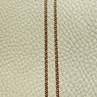18k gold watch chain necklace with dog clip on a textured light gray background