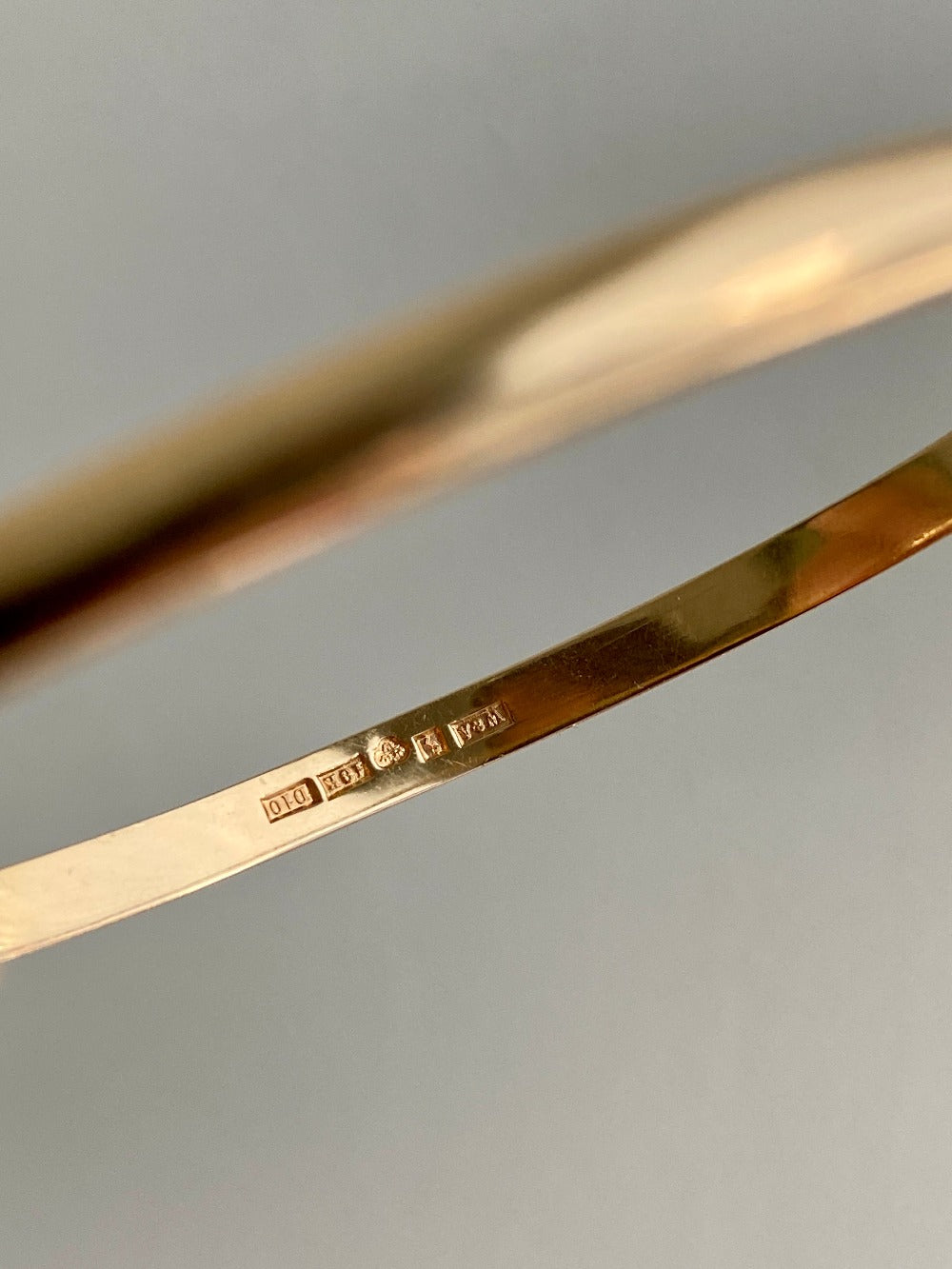 A solid gold hinged bangle made in 1978 in Sävsjö, Sweden. Solid bangles like this are rare finds! What I love about them is that they cannot dent - this style is a solid bar of gold!  This amazing vintage Scandinavian 18k gold bangle is oval shaped with a femme half-round cross section. Interior of the oval measures 2 inches (50mm) x 2.4 inches (60mm) and opens with a well working and beautiful hinge. She weighs an excellent 18.2g