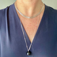 Brilliant! Black onyx faceted orb pendant necklace set in 18k white gold with 0.05 ct brilliant cut diamond by Ole Lynggaard