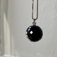 Brilliant! Black onyx faceted orb pendant necklace set in 18k white gold with 0.05 ct brilliant cut diamond by Ole Lynggaard