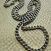 vintage 14k white gold chain necklace on a textured beige surface