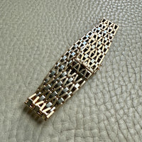 18k gold bracelet with a geometric pattern on a textured surface
