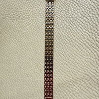 gold link bracelet on a textured beige background