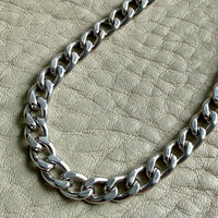 vintage 14k white gold chain necklace on a textured beige surface