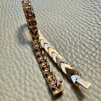 18 Gold link bracelet on a textured gray surface