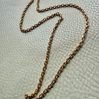 vintage 18k yellow gold biker link chain necklace on a textured light gray surface