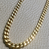 Gold chain on a textured gray surface