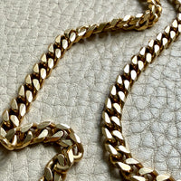 Gold chain on a textured gray surface