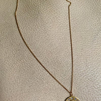 13 stone stars in circles within a solid 18k gold pendant