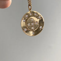 13 stone stars in circles within a solid 18k gold pendant