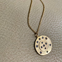 13 stone stars in circles within a solid 18k gold pendant